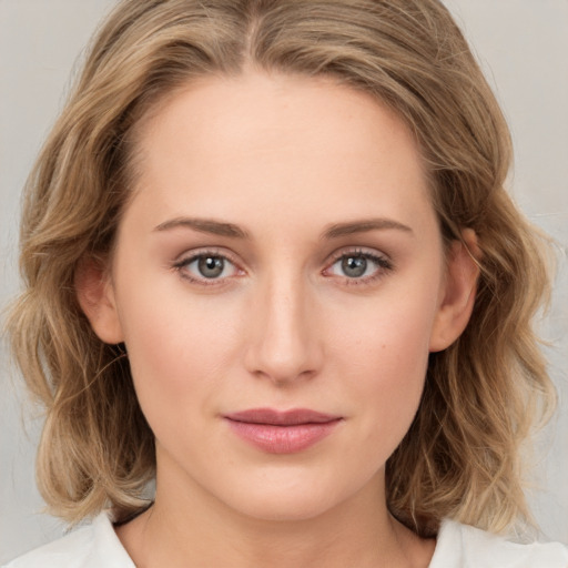 Joyful white young-adult female with medium  brown hair and green eyes