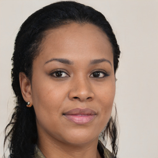 Joyful black young-adult female with long  brown hair and brown eyes