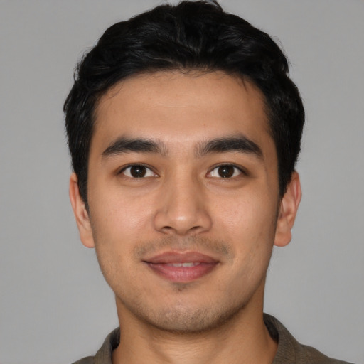 Joyful latino young-adult male with short  black hair and brown eyes