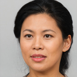 Joyful asian adult female with medium  brown hair and brown eyes