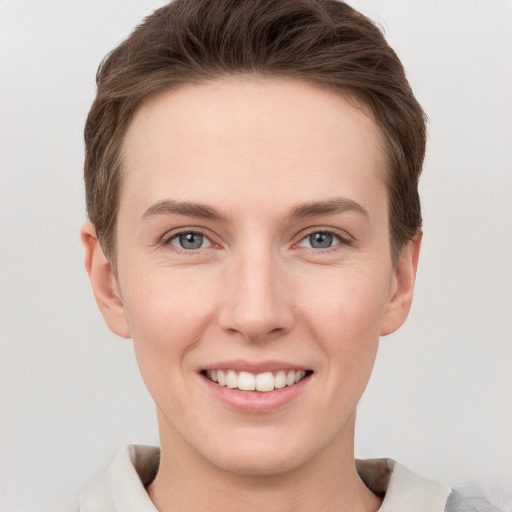 Joyful white young-adult female with short  brown hair and grey eyes