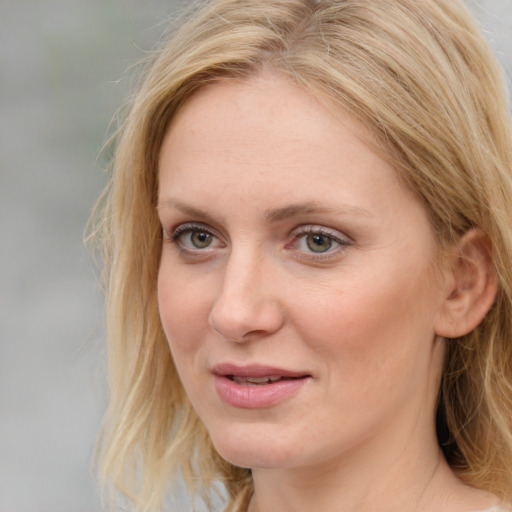 Joyful white young-adult female with medium  brown hair and blue eyes