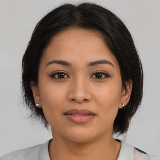 Joyful latino young-adult female with medium  black hair and brown eyes