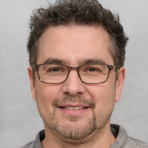 Joyful white adult male with short  brown hair and grey eyes