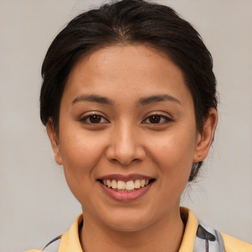 Joyful asian young-adult female with medium  brown hair and brown eyes