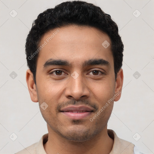 Joyful latino young-adult male with short  black hair and brown eyes