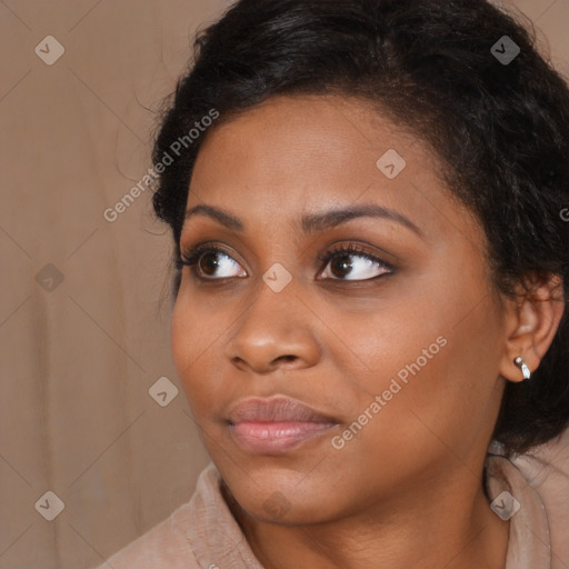 Joyful black young-adult female with long  brown hair and brown eyes