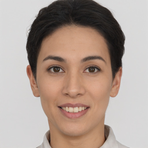 Joyful white young-adult female with short  brown hair and brown eyes