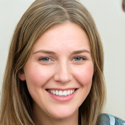 Joyful white young-adult female with long  brown hair and blue eyes