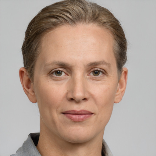 Joyful white adult female with short  brown hair and grey eyes