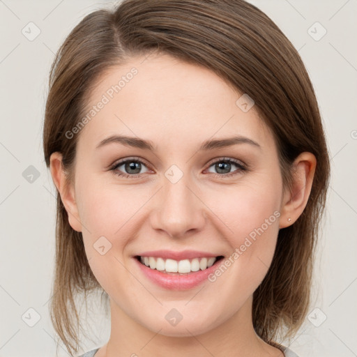 Joyful white young-adult female with medium  brown hair and grey eyes