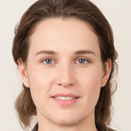 Joyful white young-adult female with medium  brown hair and green eyes