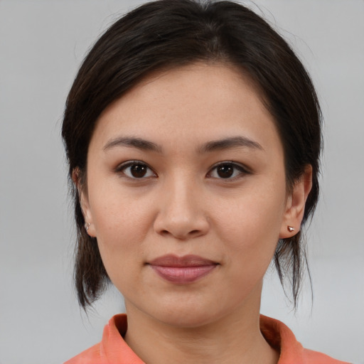 Joyful asian young-adult female with medium  brown hair and brown eyes