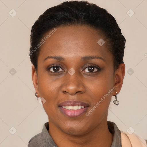 Joyful black young-adult female with short  black hair and brown eyes