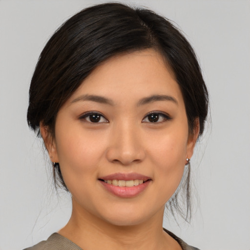 Joyful asian young-adult female with medium  brown hair and brown eyes