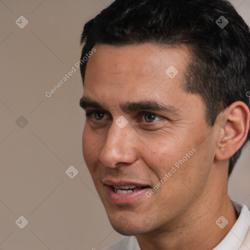 Joyful white adult male with short  black hair and brown eyes