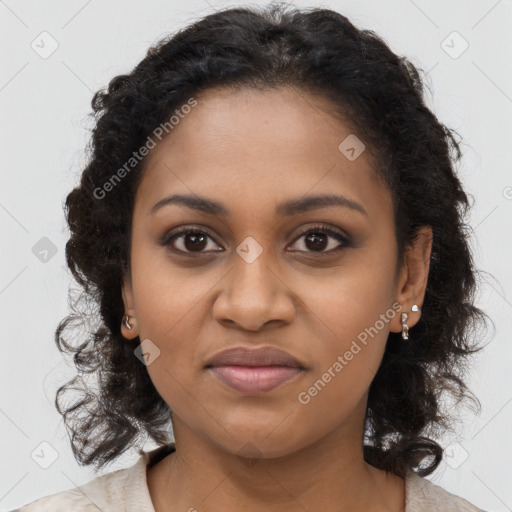 Joyful black young-adult female with long  brown hair and brown eyes