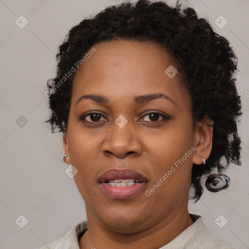 Joyful black adult female with short  brown hair and brown eyes