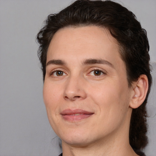 Joyful white adult male with medium  brown hair and brown eyes