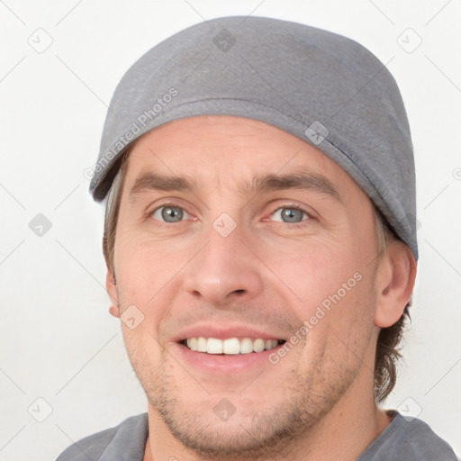 Joyful white young-adult male with short  brown hair and grey eyes