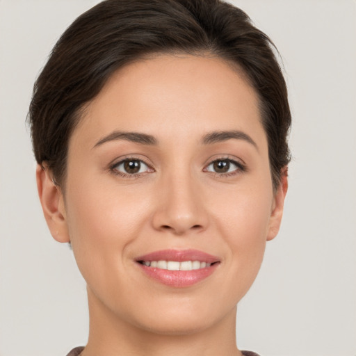 Joyful white young-adult female with short  brown hair and brown eyes