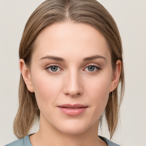 Joyful white young-adult female with medium  brown hair and blue eyes