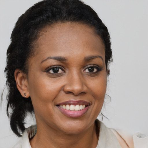 Joyful black young-adult female with medium  brown hair and brown eyes