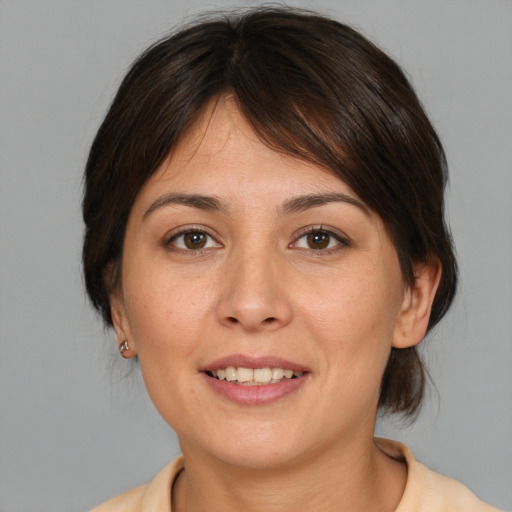 Joyful white young-adult female with medium  brown hair and brown eyes