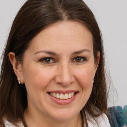 Joyful white adult female with medium  brown hair and brown eyes