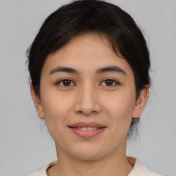 Joyful asian young-adult female with medium  brown hair and brown eyes