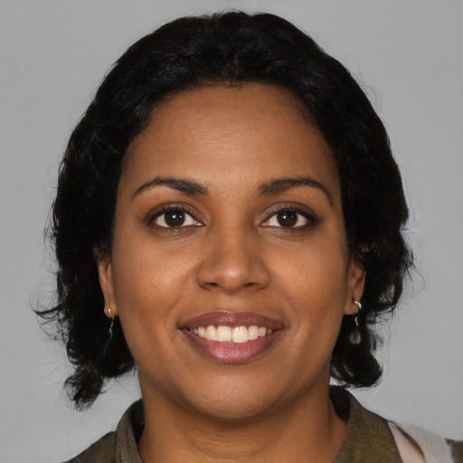 Joyful black young-adult female with medium  black hair and brown eyes
