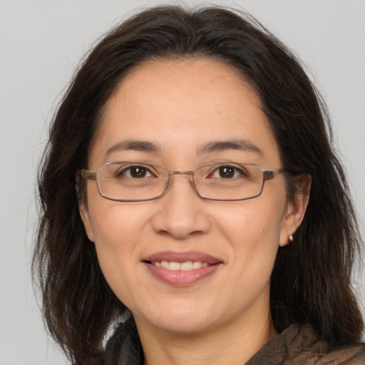 Joyful white adult female with long  brown hair and brown eyes