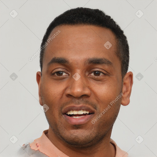 Joyful black young-adult male with short  black hair and brown eyes