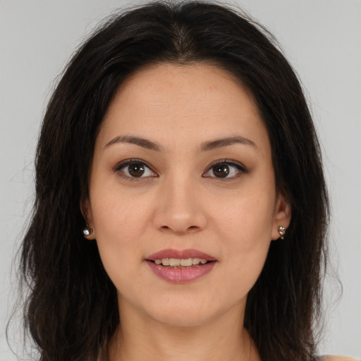 Joyful latino young-adult female with long  brown hair and brown eyes