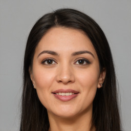 Joyful white young-adult female with long  brown hair and brown eyes