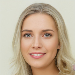 Joyful white young-adult female with long  brown hair and blue eyes