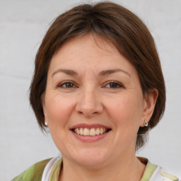 Joyful white adult female with medium  brown hair and brown eyes