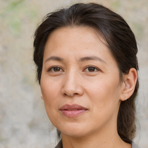 Joyful white adult female with medium  brown hair and brown eyes