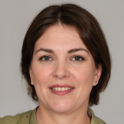 Joyful white adult female with medium  brown hair and brown eyes