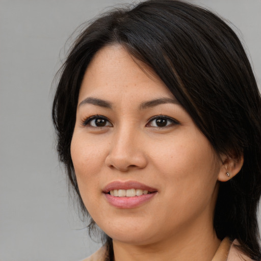 Joyful asian young-adult female with medium  brown hair and brown eyes