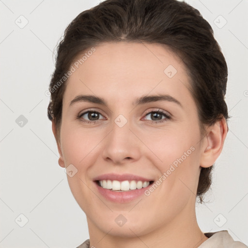 Joyful white young-adult female with short  brown hair and brown eyes