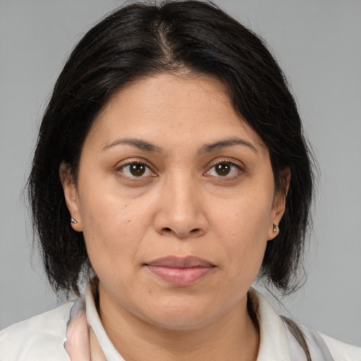 Joyful white adult female with medium  brown hair and brown eyes