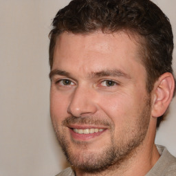 Joyful white adult male with short  brown hair and brown eyes