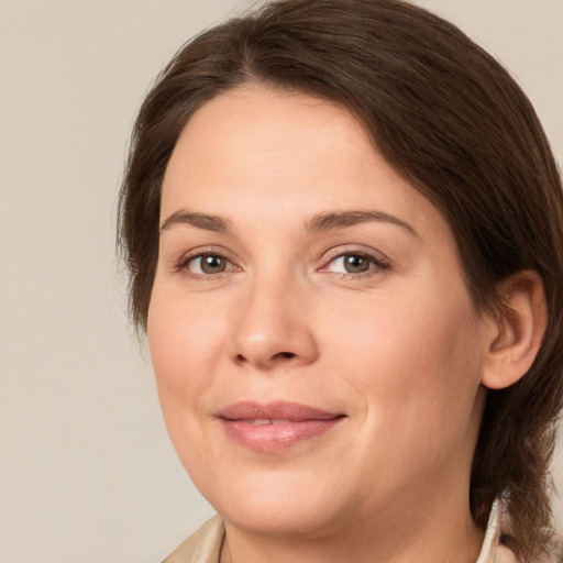 Joyful white young-adult female with medium  brown hair and brown eyes