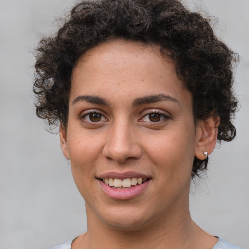 Joyful white young-adult female with short  brown hair and brown eyes