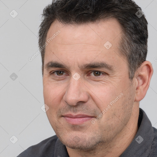 Joyful white adult male with short  brown hair and brown eyes