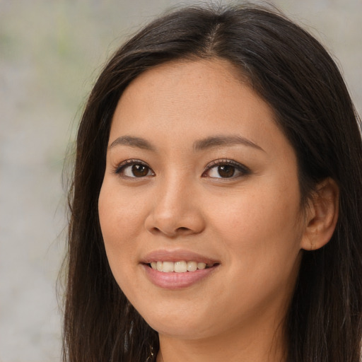 Joyful asian young-adult female with long  brown hair and brown eyes