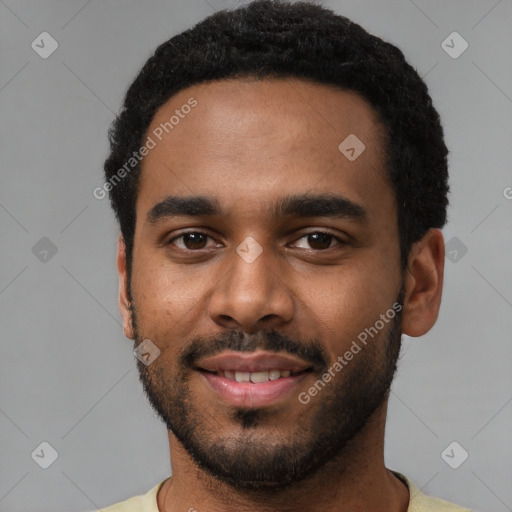 Joyful black young-adult male with short  black hair and brown eyes