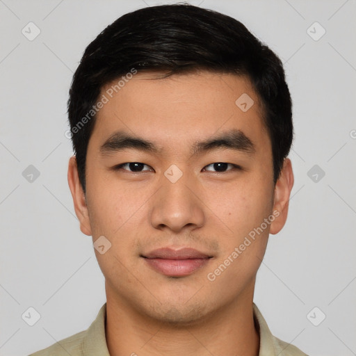 Joyful asian young-adult male with short  black hair and brown eyes