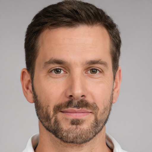 Joyful white adult male with short  brown hair and brown eyes